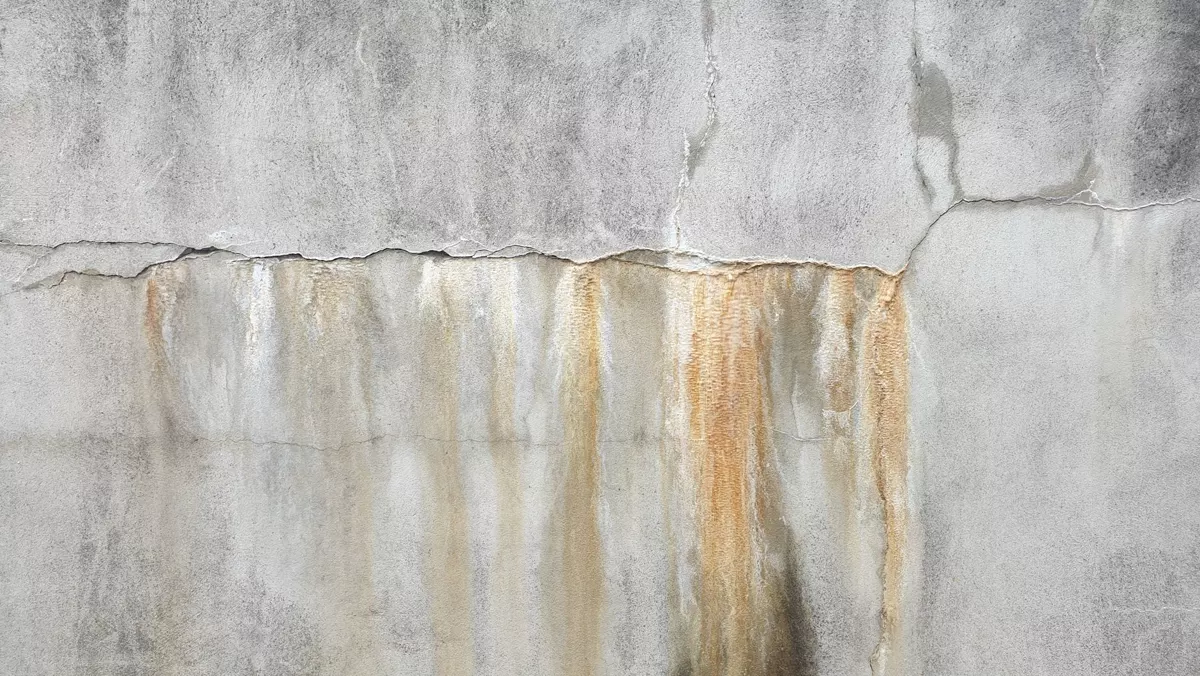 Signs of hidden water damage behind walls and under floors